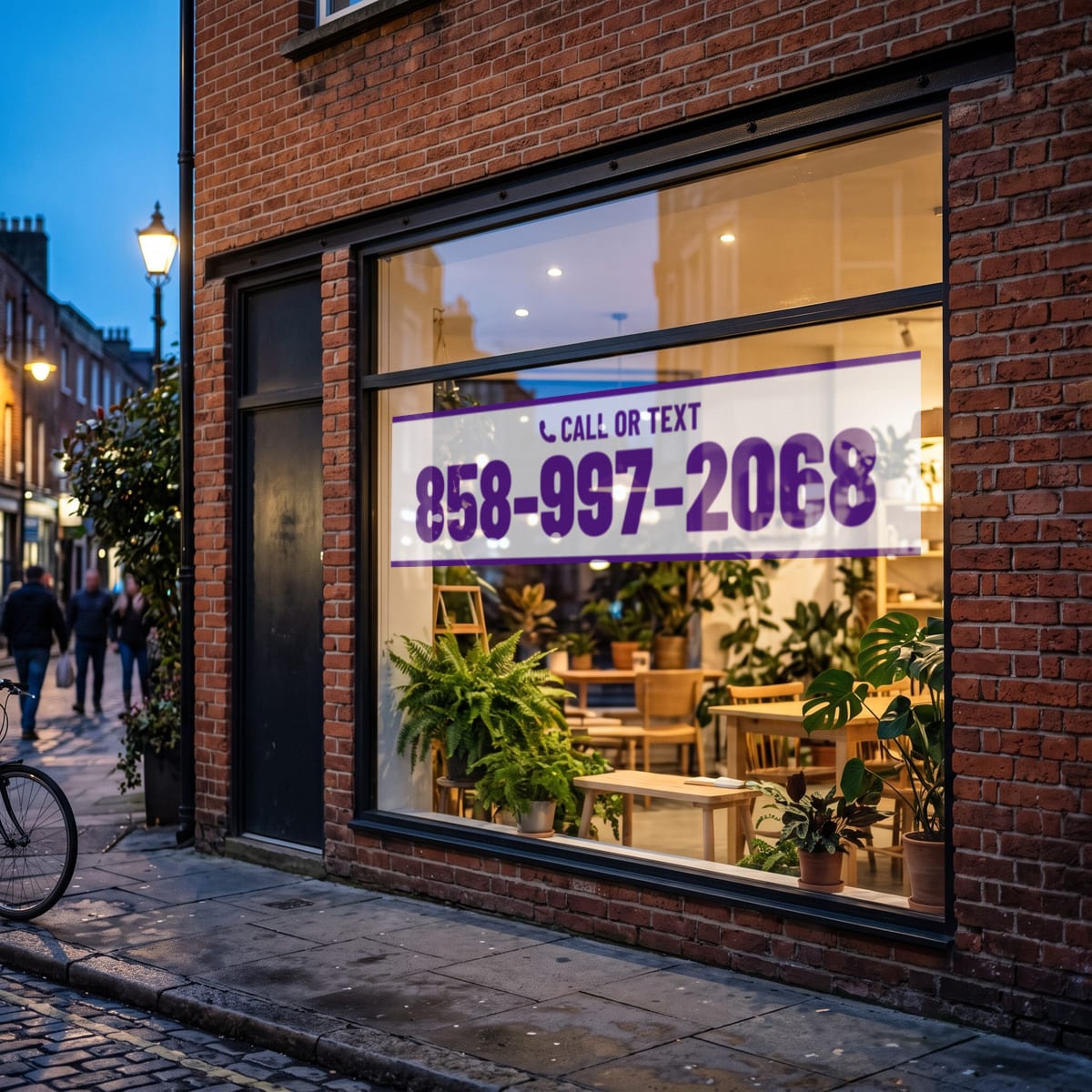 (858) 997-2068 on a shop window